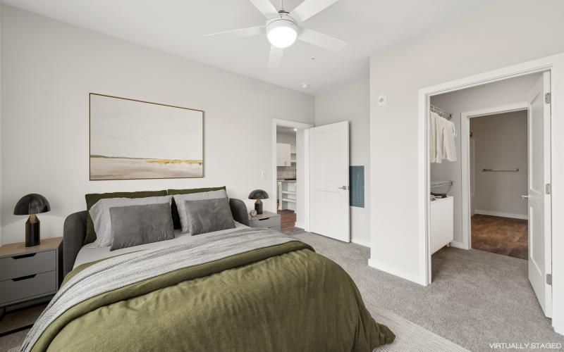 a bedroom with a bed and a fan