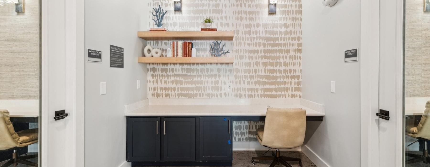 a room with a desk and chairs