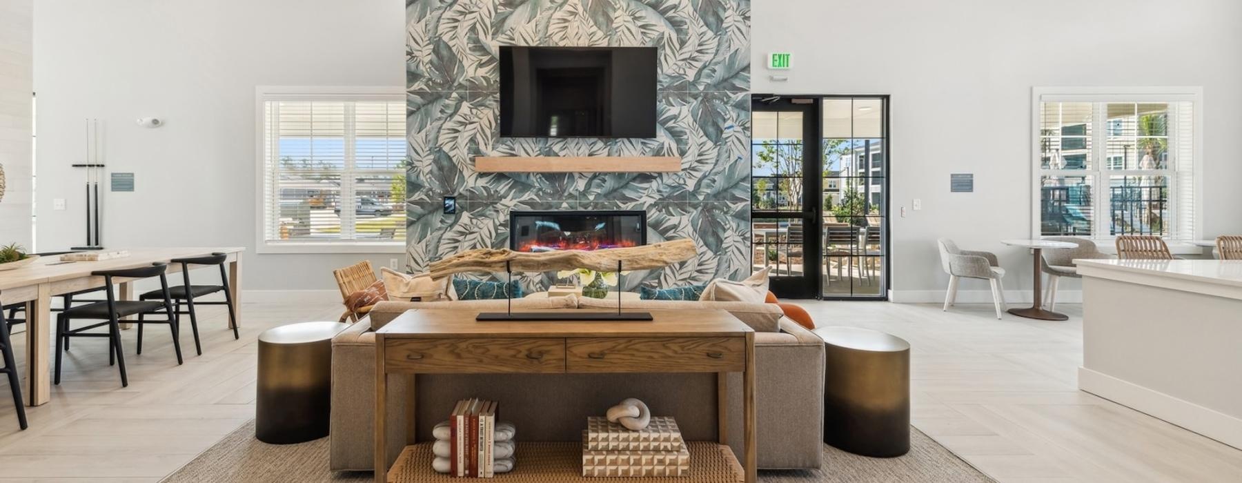 a large room with a fireplace and a tv mounted above it